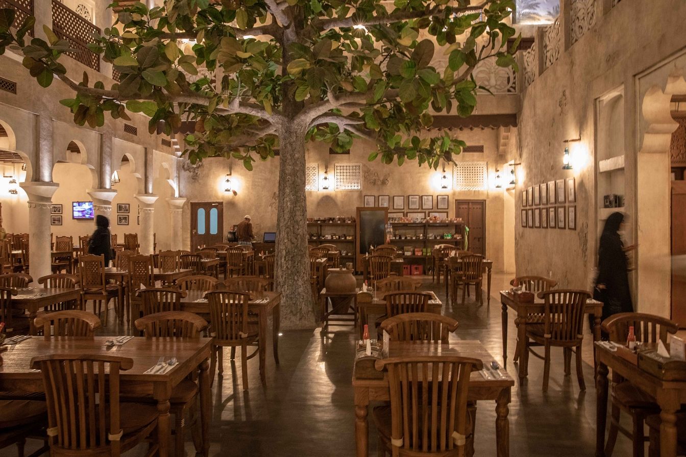 The Al Ain dining courtyard beneath a great tree