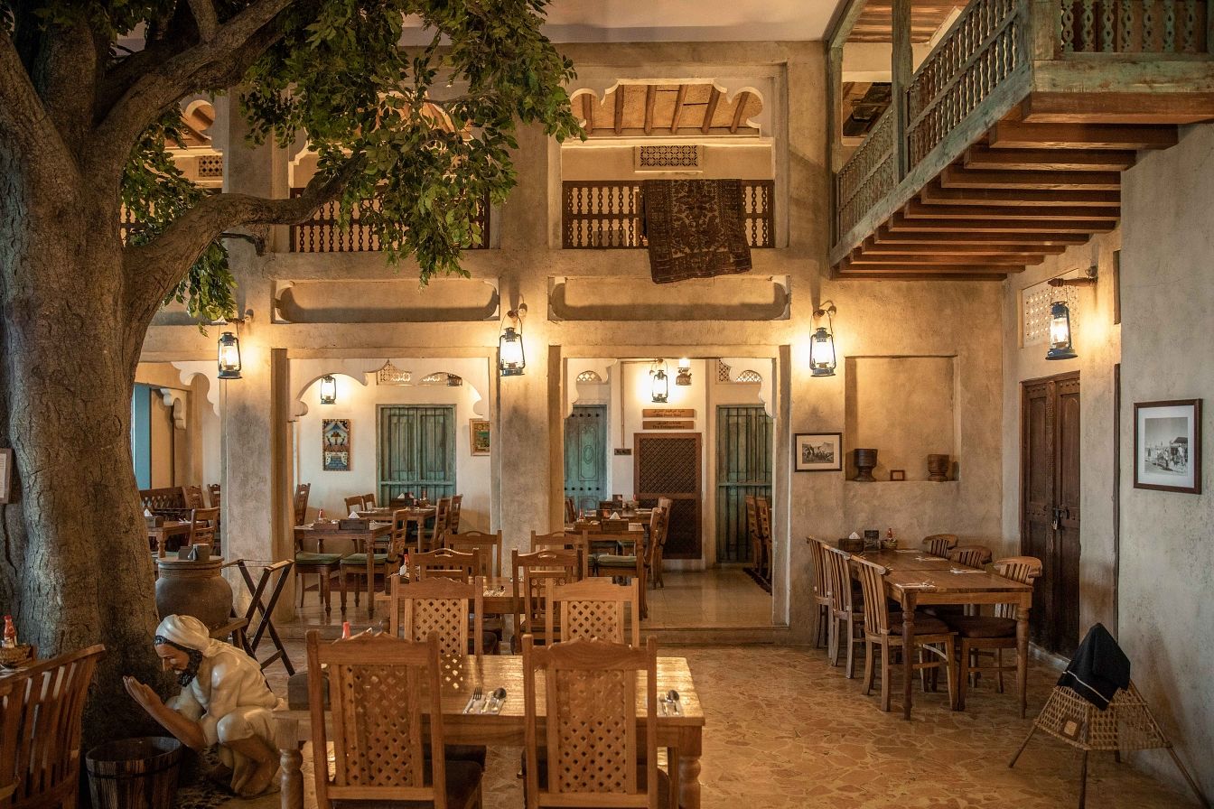 The courtyard dining room at Dubai Festival City, under a great tree with wooden balconies