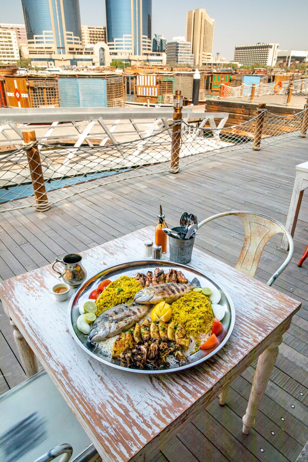 Seafood tray on the Al Seef terrace, with Dubai Creek and the city skyline behind